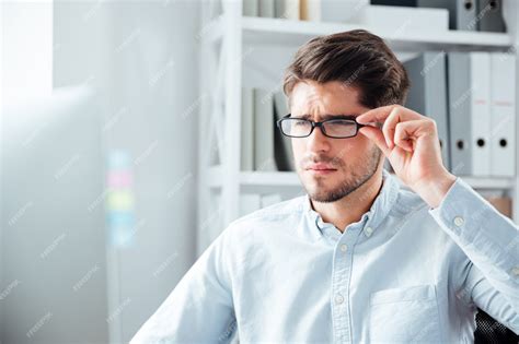 Premium Photo Close Up Portrait Of A Pensive Young Handsome Businessman In Eyeglasses Looking