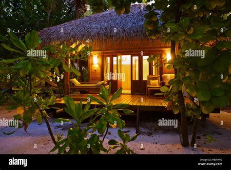 Beach bungalow at sunset - Maldives Stock Photo - Alamy