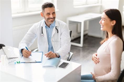 Prenatal Care Concept. Happy Young Pregnant Lady Sitting at Clinic ...