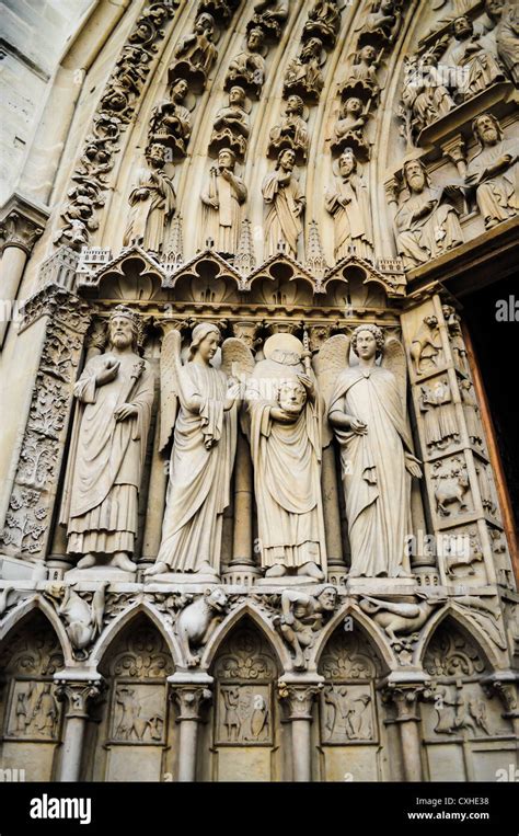 The Sculpture At The Entrance Of Notre Dame Cathedral In Paris France