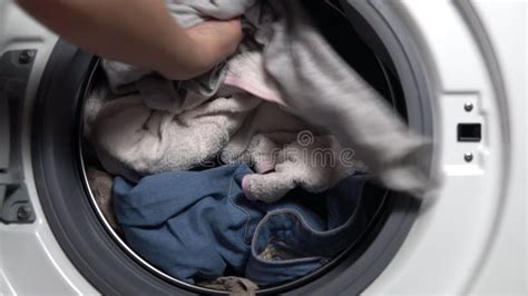 Girl Loads Dirty Things Into The Washing Machine Close Up Stock Footage