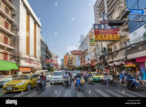 Chinatown District With Its Typical Lit Signs And Traffic On Thanon