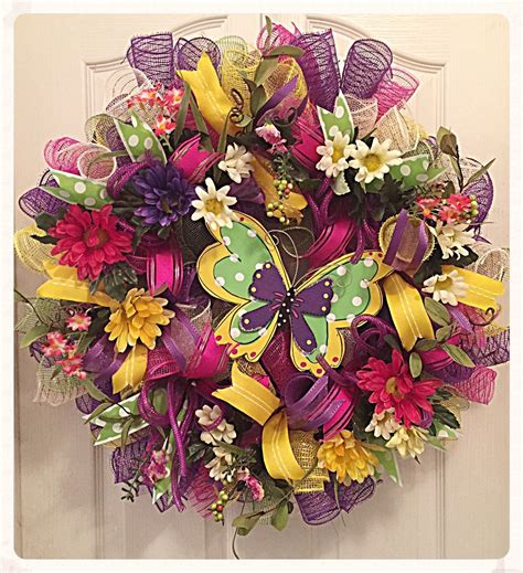 A Purple And Yellow Butterfly Wreath Hanging On A Door