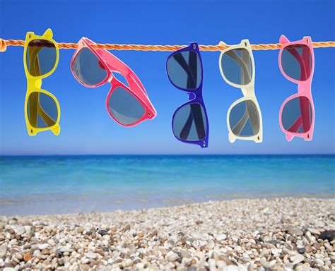 Premium Photo Collection Of Sunglasses On The Beach