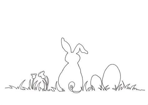 a rabbit sitting in the grass next to an egg and another bunny standing ...