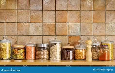 Kitchen Shelf For Storing Food In Glass Jars On A Tiled Wall Stock