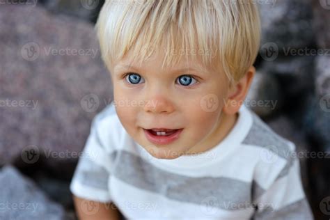 Cute boy with blond hair and blue eyes 5564026 Stock Photo at Vecteezy