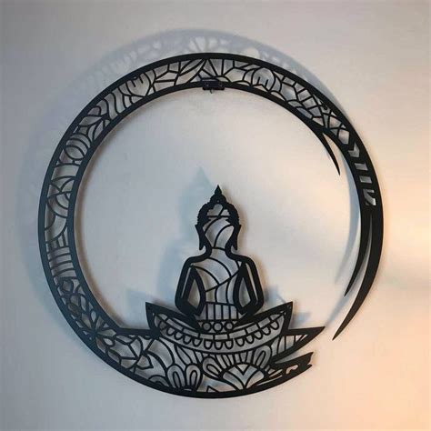 A Metal Wall Hanging With A Buddha Sitting On A Boat In The Middle Of It