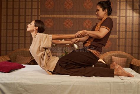 Practitioner Doing Kneeling Assisted Cobra Spinal Stretch Stock Image