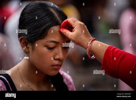 lalitpur nepal  aug   devotee receives tika   forehead