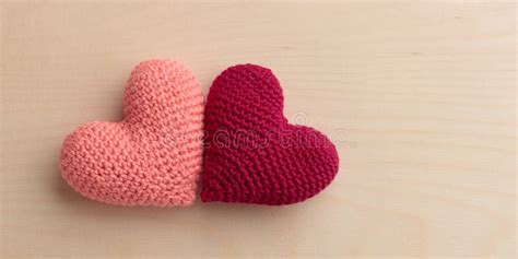 Two Crocheted Amigurumi Pink Hearts On A Wooden Background Valentine S