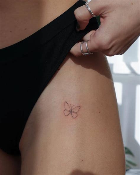 Fine Line Style Butterfly Tattoo Located On The Pelvis