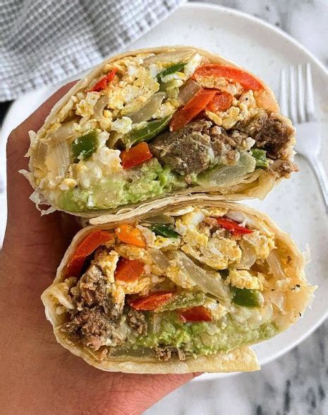 Burrito filled with 2 scrambled eggs with bell peppers, onions