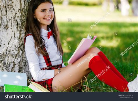 Young Schoolgirl School Uniform Sitting On Stock Photo 1209376738