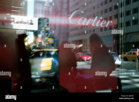 Fifth Avenue traffic is reflected in window of Cartier Jewelers in ...
