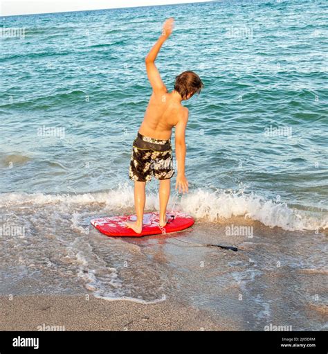 boy learning surfing at the beach Stock Photo - Alamy