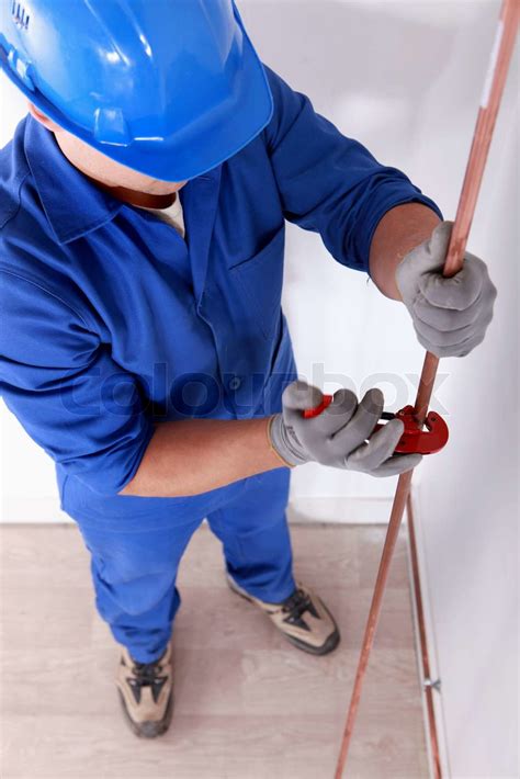 Tradesman using a tool | Stock image | Colourbox