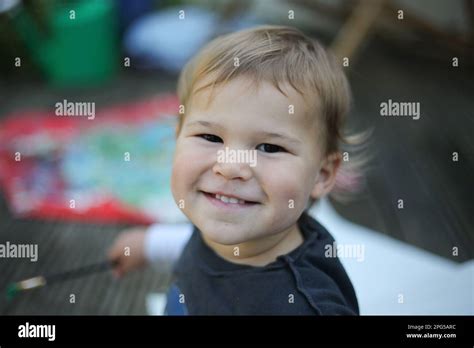 Happy Baby Sitting Outdoors Smiling Stock Photo Alamy