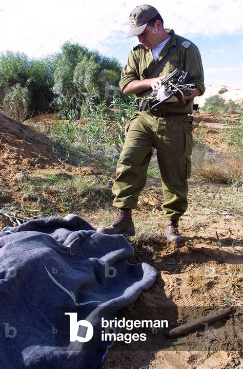 Image Of Israeli Soldier Stands Over Covered Body Of Palestinian Gunman