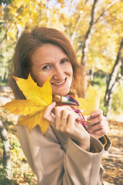 Premium Photo Girl Holds A Yellow Leaf