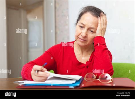 Mature Woman Reads Documents Hi Res Stock Photography And Images Alamy