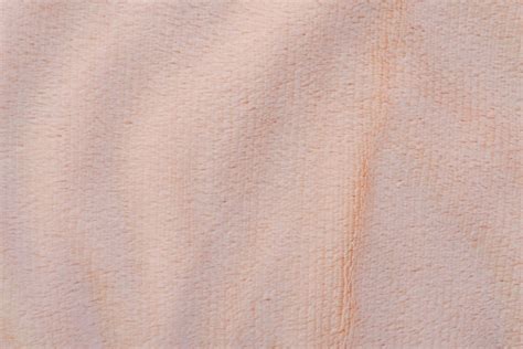 Premium Photo | The texture of this fabric is from a peach color.