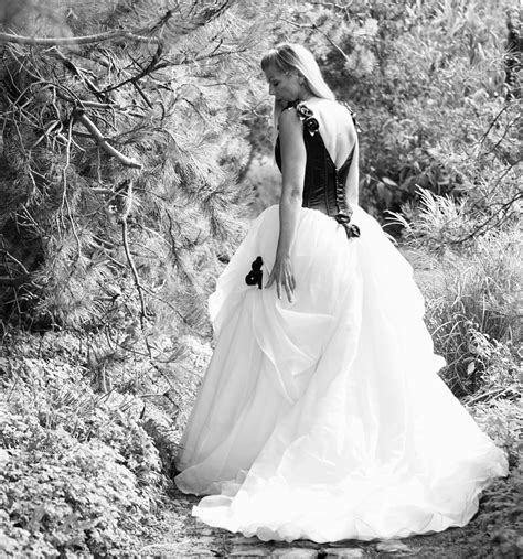 Woman in white wedding dress standing on the ground photo – Free Bride