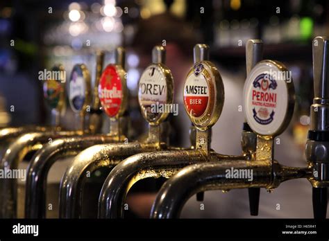 Row of lager and beer taps on a pub bar, Peroni, Amstel, Korev Stock ...