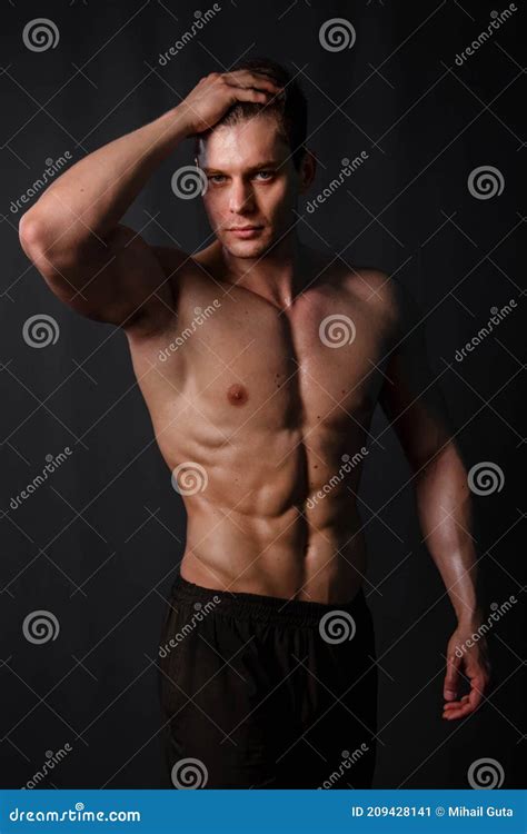 Muscular Bodybuilder Posing With A Naked Torso Against A Black Background Stock Image Image