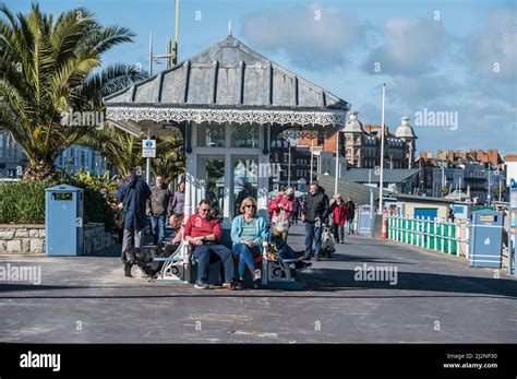 Colourful Scenes Of Holiday Makers Relaxing On Weymouths Esplanade