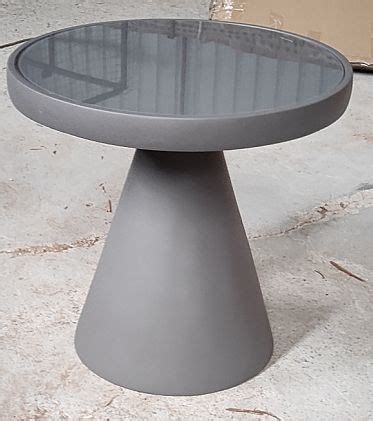 A Grey Table Sitting On Top Of A White Floor Next To A Cardboard Box In