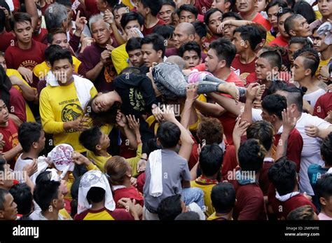 Filipino Roman Catholic Devotees Carry A Woman After She Collapsed