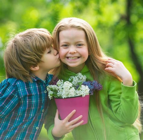 Premium Photo Two Little Children Hug And Kiss Each Other In Summer