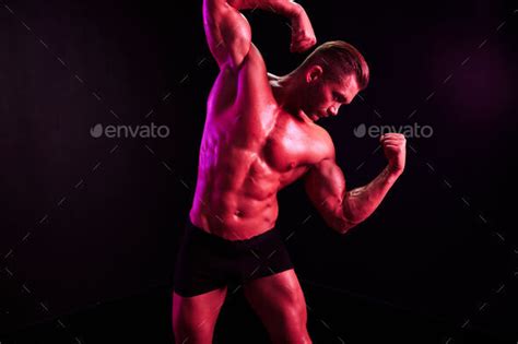Man Professional Athletes With Naked Torso In Athletic Uniforms Isolated On A Multicolored