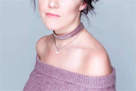 Choker Made Of Chains And Velvet With A Bead Shaped Pendant Around The Neck Of A Brunette Girl