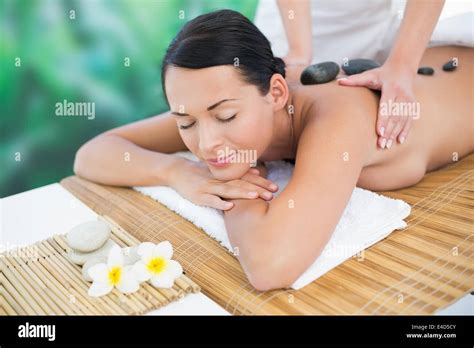 Beautiful Brunette Enjoying A Hot Stone Massage Stock Photo Alamy