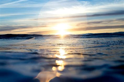 Sun Setting Over Blue Pacific Ocean Stock Photo Image Of Flare