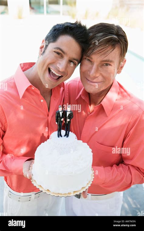 Newlywed Gay Couple Displaying Grooms On Their Wedding Cake Stock Photo Alamy