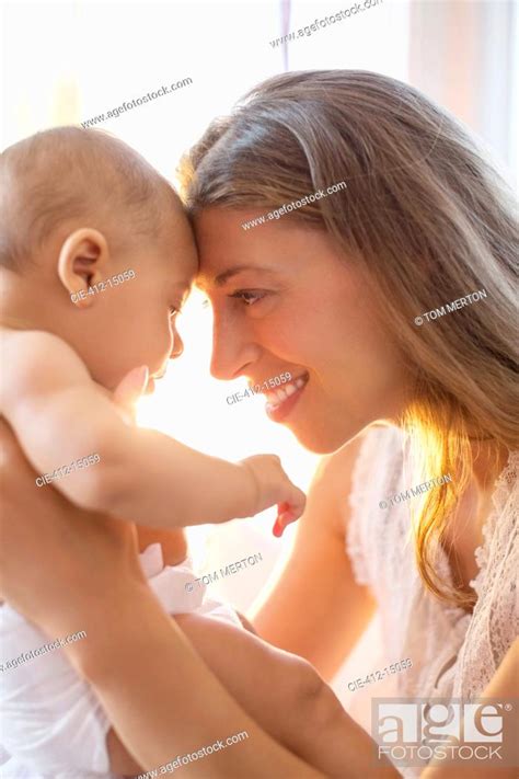 Mother Touching Foreheads With Baby Boy Stock Photo Picture And