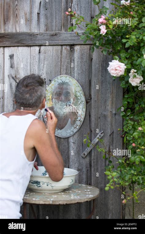 Mature Man Shaving Outdoors Stock Photo Alamy