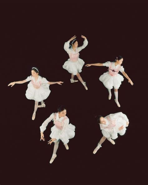 Four Ballerinas In White Tutus Are Dancing Together