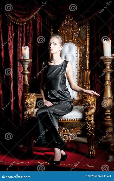 Portrait Of Elegance Attractive Woman Sitting On Throne Stock Photo