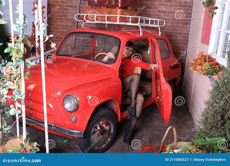 Brunette Legged Photomodel In Black Minidress And Stockings Posing In Studio Stock Image Image