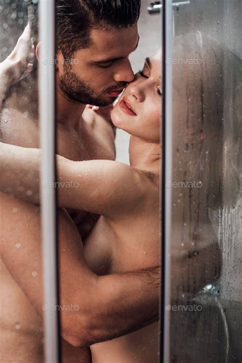 Passionate Naked Couple Hugging And Kissing While Taking Shower Together Stock Photo By