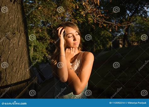 Street Portrait Of Young Adorable Model With Closed Eyes Posing Stock