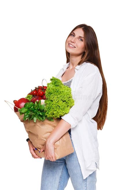 Smiling Young Woman Holding Shopping Bag Full Of Vegetables Isolated On