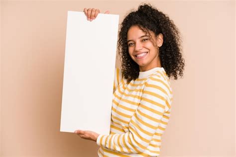 Premium Photo Young African American Woman Holding A Banner Isolated