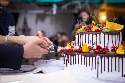 Premium Photo A Person Is Cutting A Cake With A Knife And The Word