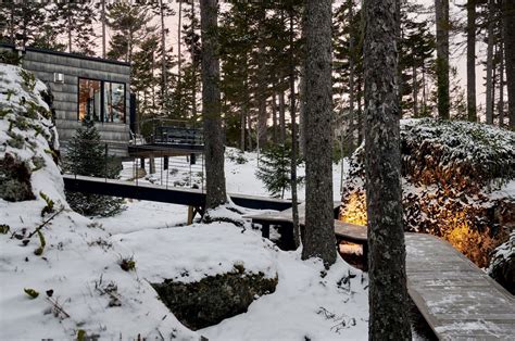 A Floating Cabin With A Winding Boardwalk Is The Magical Winter Retreat