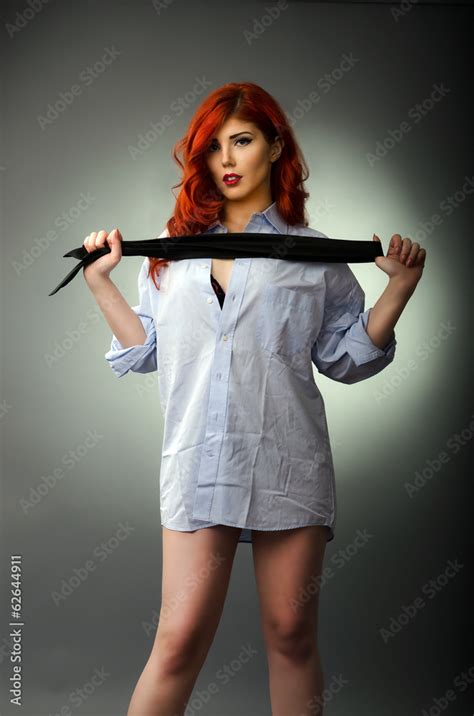 Sexy woman holding a men`s tie ready for spanking Stock Photo | Adobe Stock